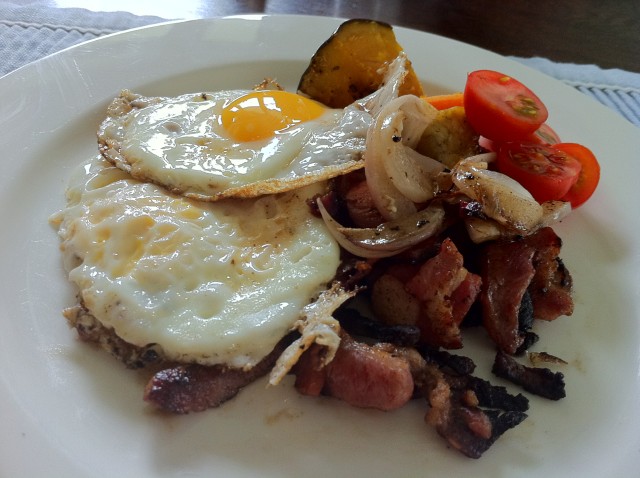 bacon and eggs with roast pumpkin, tomato and onion